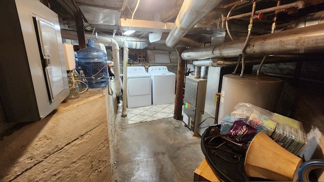 basement featuring independent washer and dryer and water heater