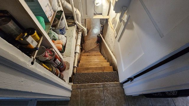 stairway with tile patterned floors