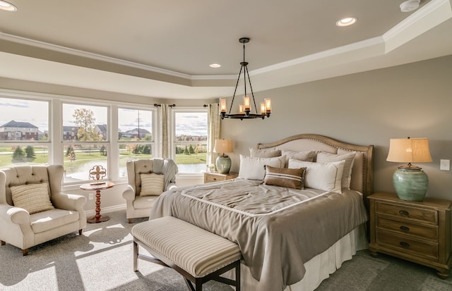 bedroom with ornamental molding, a raised ceiling, dark colored carpet, and a notable chandelier