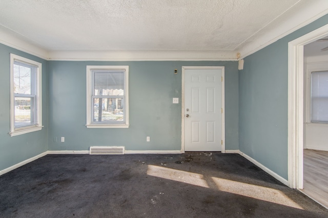 interior space featuring carpet flooring and a textured ceiling