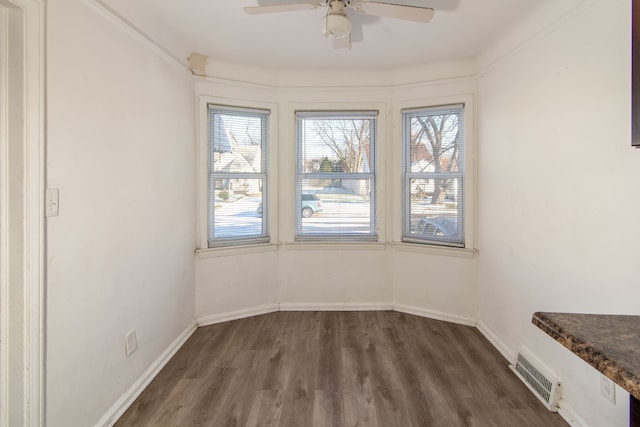 interior space with ceiling fan, crown molding, and dark hardwood / wood-style floors