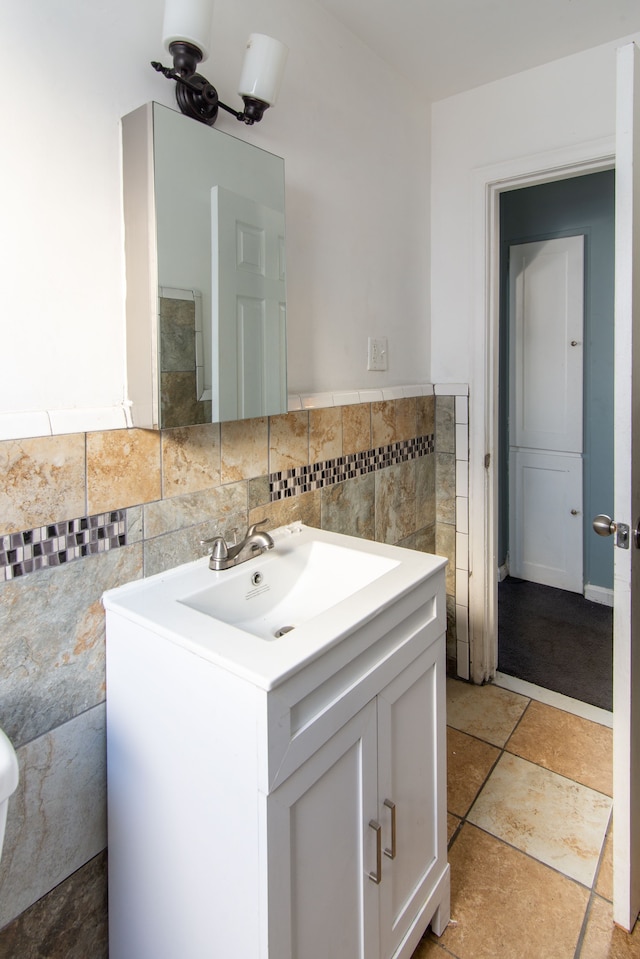 bathroom with vanity and tile walls