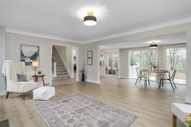 sitting room with plenty of natural light and light hardwood / wood-style flooring