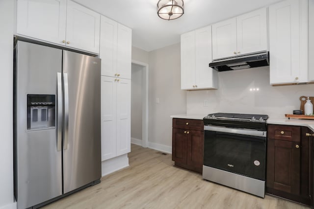 kitchen featuring dark brown cabinets, stainless steel appliances, and light hardwood / wood-style flooring