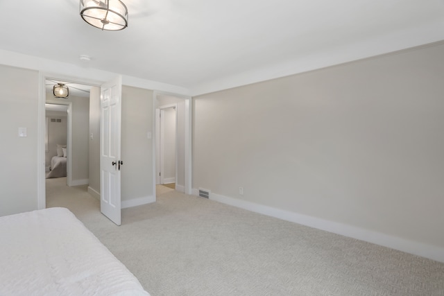 bedroom featuring light carpet