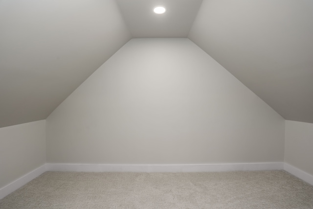 bonus room featuring carpet floors and vaulted ceiling