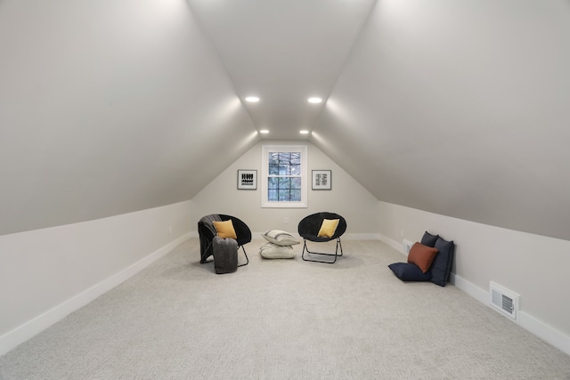 unfurnished room featuring carpet flooring and vaulted ceiling