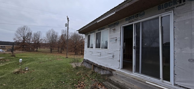 view of side of property with a lawn