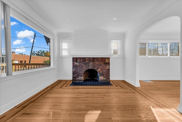 unfurnished living room with a fireplace and hardwood / wood-style flooring