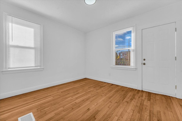 unfurnished room featuring light hardwood / wood-style floors and a healthy amount of sunlight