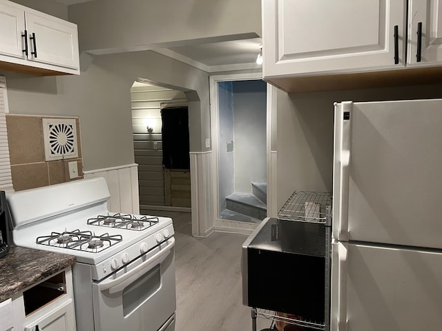 kitchen featuring light hardwood / wood-style floors, white cabinetry, and white appliances