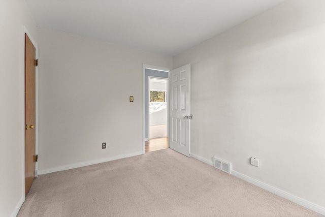 empty room featuring light colored carpet