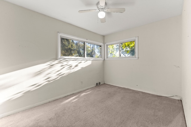 carpeted spare room with ceiling fan