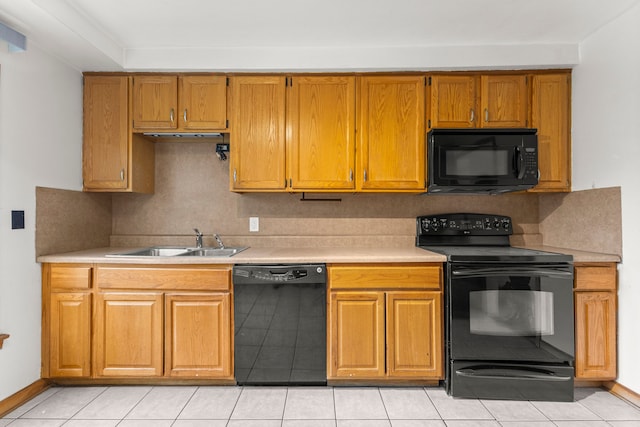 kitchen featuring sink, decorative backsplash, and black appliances