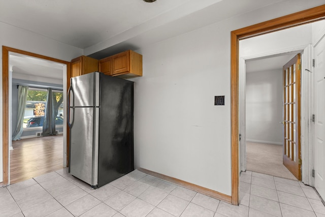 kitchen with stainless steel refrigerator and light tile patterned flooring