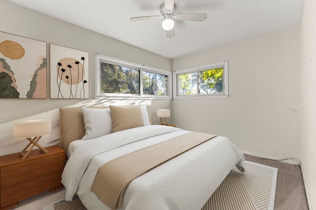 bedroom featuring ceiling fan and carpet