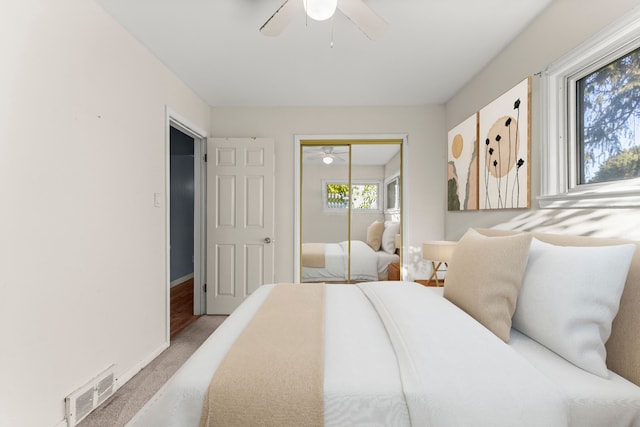 carpeted bedroom with a closet and ceiling fan