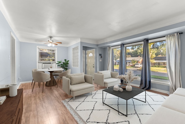 living room with ceiling fan and light wood-type flooring