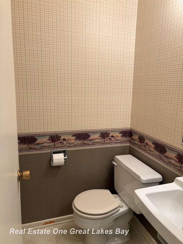 2377 Bay Woods Ct, Bay City, MI 48706 - bathroom with wallpapered walls and tile patterned floors