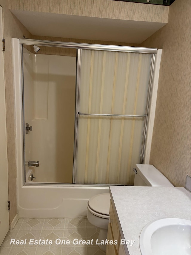 2377 Bay Woods Ct, Bay City, MI 48706 - full bath featuring vanity, tile patterned floors, and bath / shower combo with glass door