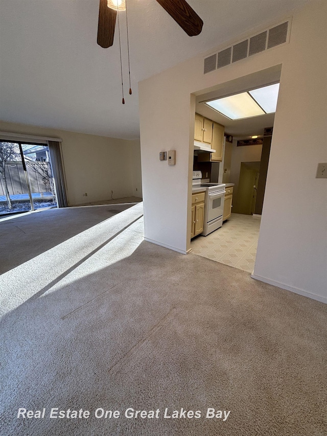 unfurnished living room with ceiling fan and light colored carpet