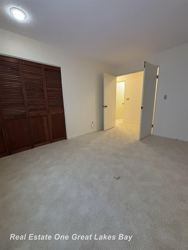 unfurnished bedroom with a closet and a textured ceiling