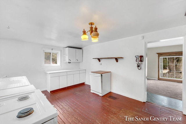 kitchen featuring dark wood-type flooring, white fridge, washer / dryer, white cabinets, and range