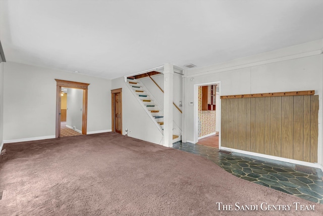 unfurnished living room with dark colored carpet