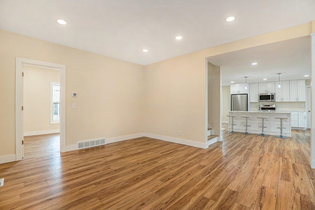 unfurnished living room with light wood-type flooring