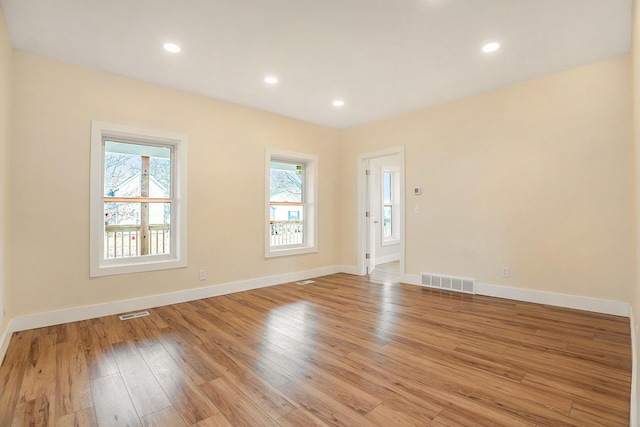 empty room with light hardwood / wood-style flooring