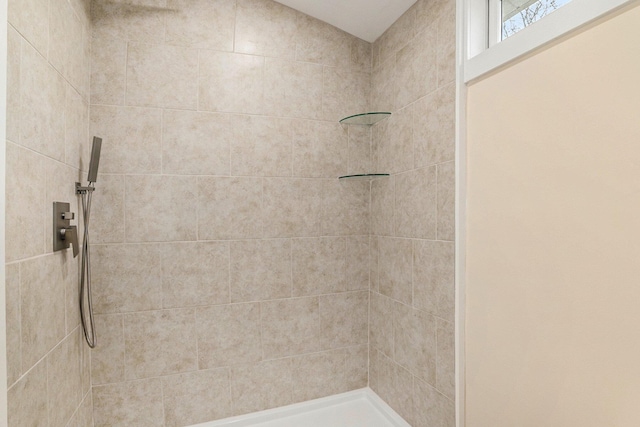 bathroom with a tile shower