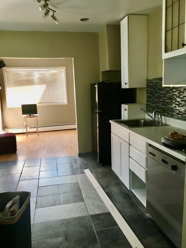 kitchen featuring white cabinets, tasteful backsplash, baseboard heating, sink, and dishwasher