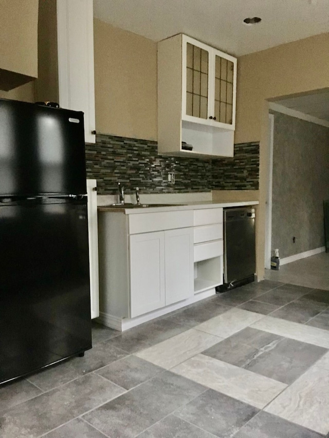 kitchen featuring white cabinetry, decorative backsplash, sink, and black appliances