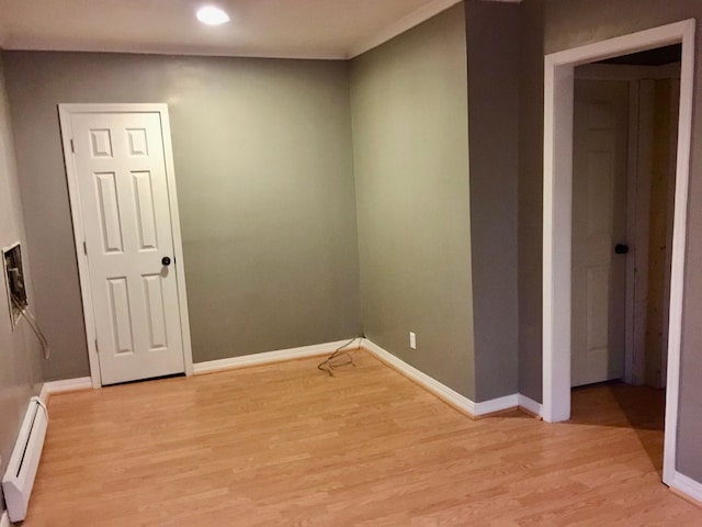 spare room with light hardwood / wood-style flooring and a baseboard radiator