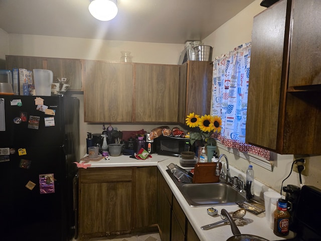 kitchen featuring sink and black appliances