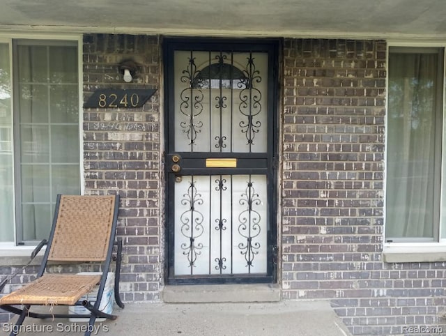 8240 Desoto St, Detroit, MI 48238 - doorway to property featuring brick siding