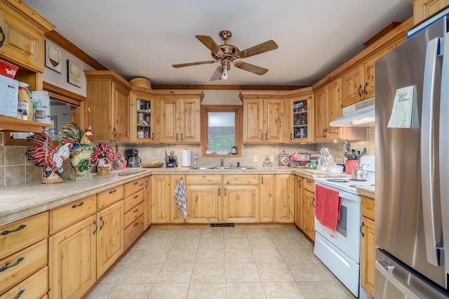 kitchen featuring white electric range, sink, decorative backsplash, stainless steel fridge, and light tile patterned floors