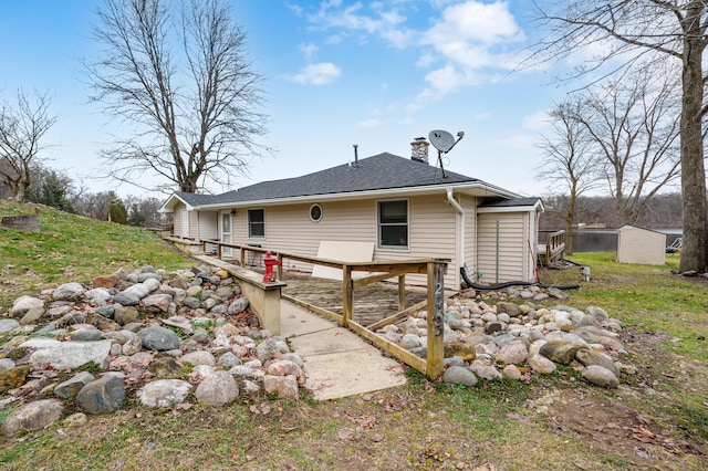 rear view of house featuring a wooden deck