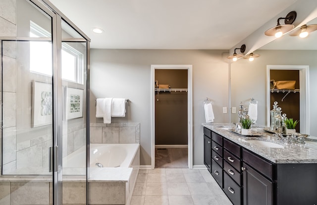 bathroom with vanity, independent shower and bath, and tile patterned flooring