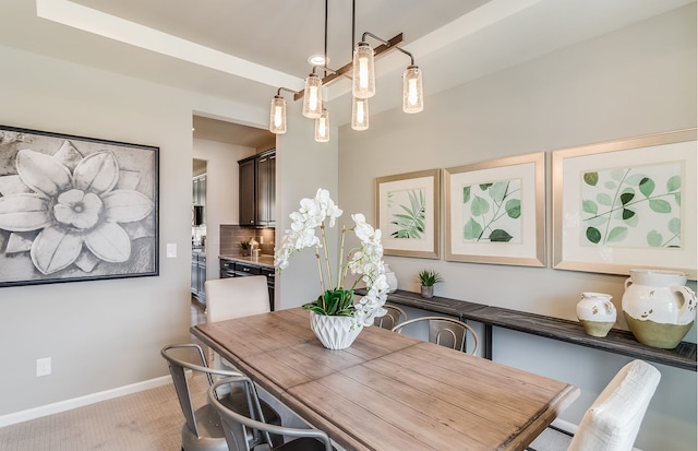 dining area featuring light carpet