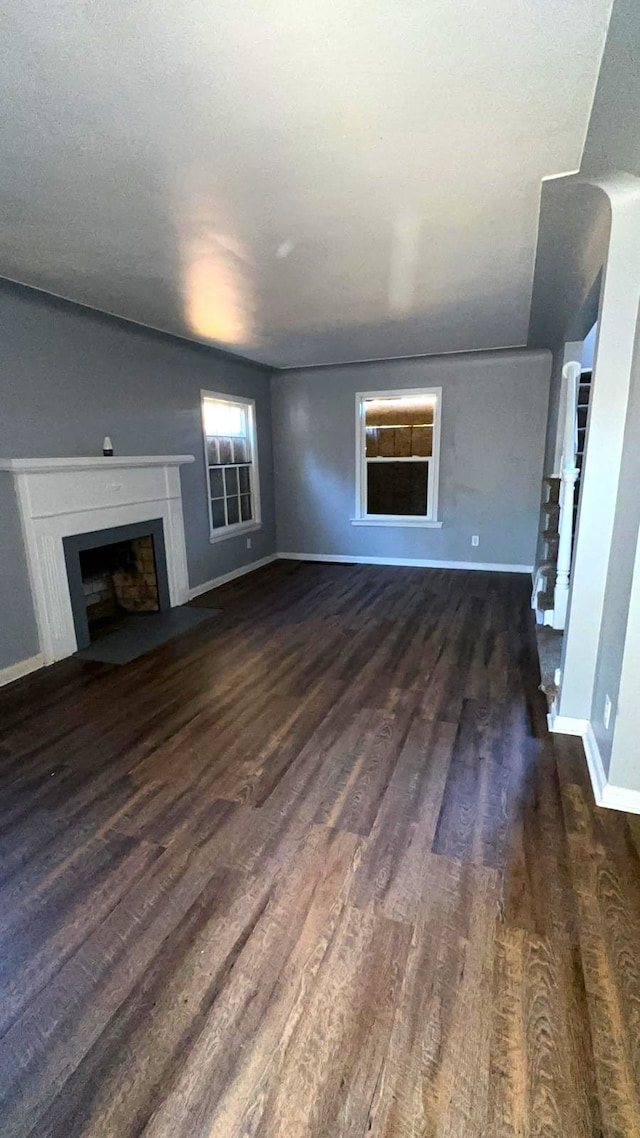 unfurnished living room with dark hardwood / wood-style flooring