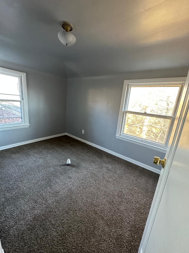 carpeted empty room with plenty of natural light and a textured ceiling