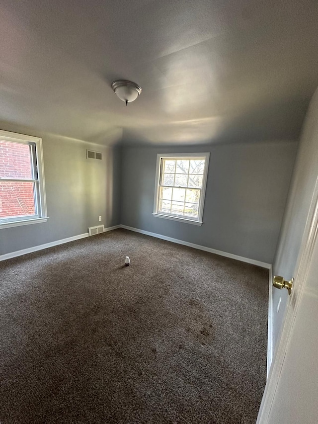 carpeted spare room featuring a textured ceiling