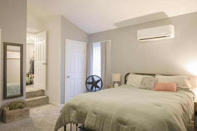 bedroom with carpet floors, an AC wall unit, vaulted ceiling, and baseboards