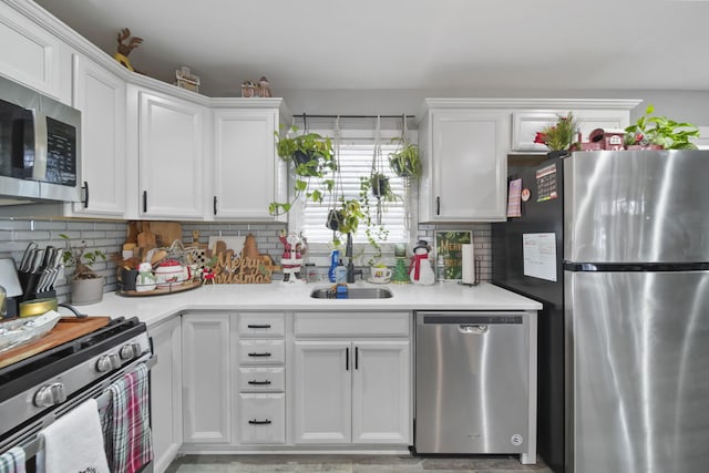 kitchen with stainless steel appliances and white cabinetry