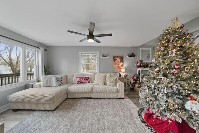 living room featuring ceiling fan and a healthy amount of sunlight