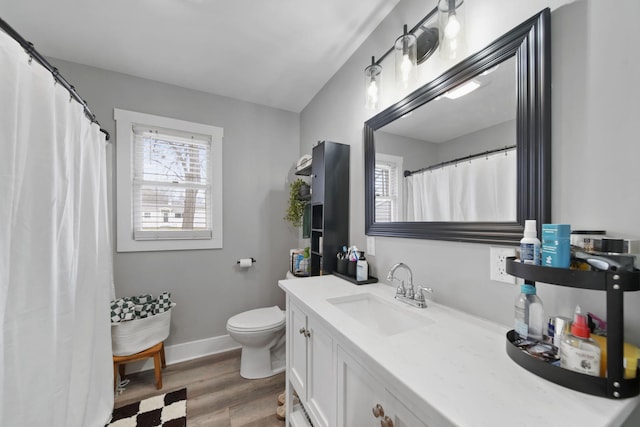 bathroom featuring wood-type flooring, vanity, and toilet