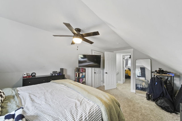 carpeted bedroom with ceiling fan and vaulted ceiling