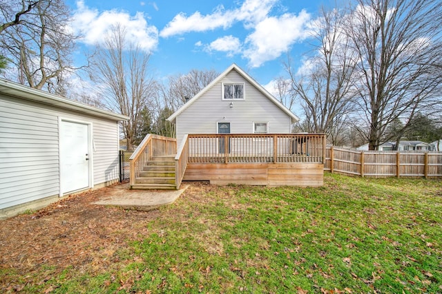 rear view of property with a lawn and a wooden deck