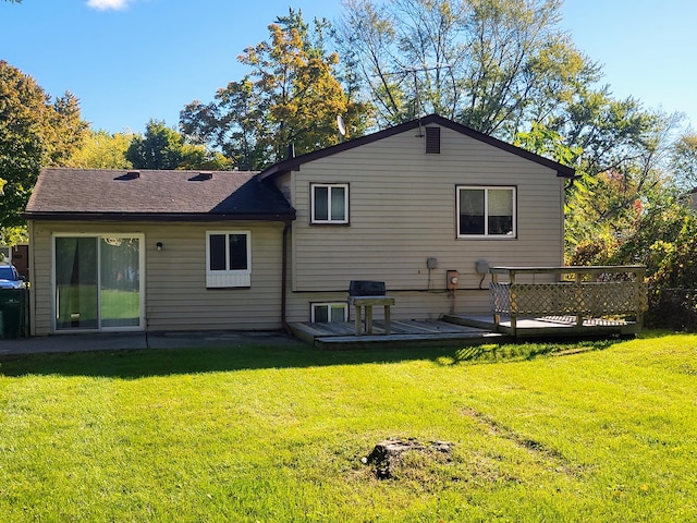 back of house featuring a yard and a wooden deck